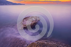 Long exposure image of Dramatic sky seascape with rock in sunset or sunrise sky scenery background. Amazing light nature landscape