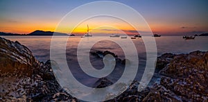 Long exposure image of Dramatic sky seascape with rocks in the foreground sunset or sunrise scenery background Beautiful light of