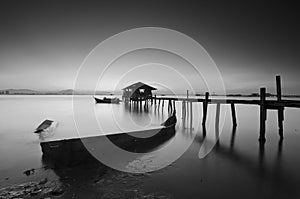 Long exposure image of old abandoned fisherman jetty in black and white