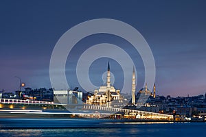 Long exposure of Istanbul at dusk with boats passing by Bosphorus canal and mosque. Scenic view of Istanbul in Turkey with Galata