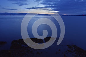 Long exposure of Juan de Fuca Strait taken from Ogden Point Breakwater at low tide during the blue hour,