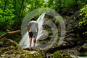 Long exposure of the Kesselbach Falls in Kochel am See with a man looking at it