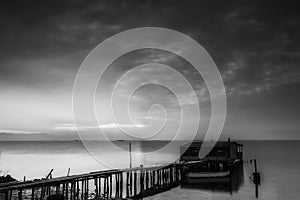 Long exposure of magic sunrise over the ocean with a hut in the