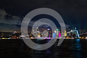 Long exposure night shot of the city center of the Sydney skyline looking over the opera house during vivid