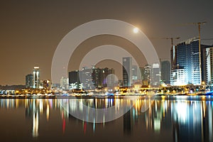 Long exposure night view of Marginal de Luanda with full moon and Mars moments before lunar eclipse