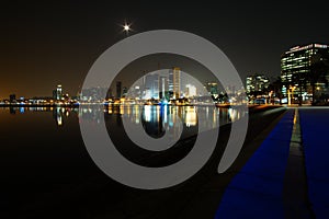 Long exposure night wide angle view of Marginal de Luanda with full moon and Mars moments after the beginning of lunar eclipse