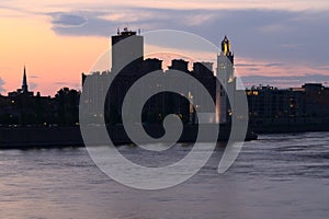 Long exposure of the old port clock tour in Montreal at the twilight blue hour with moody cloudy sky background