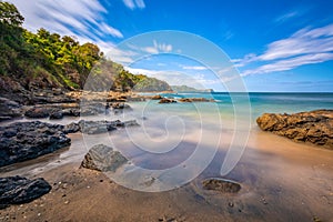 Long exposure, pacific ocean waves on rock in Playa Ocotal, El Coco Costa Rica