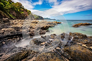 Long exposure, pacific ocean waves on rock in Playa Ocotal, El Coco Costa Rica