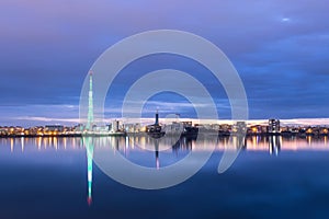 Long exposure photo of a beautiful sunset at Lacul Morii Lake with urban buildings in the background and a tower that looks like a