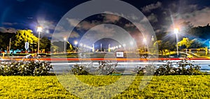 long exposure photo in front of marques de pombal park with vehicles passing by leaving light trails behind them