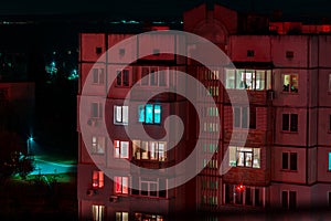 Long exposure photo of high-rise buildings in red and blue lights. Night cityscape. Big city life