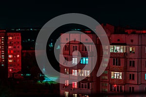 Long exposure photo of high-rise buildings in red and blue lights. Night cityscape. Big city life