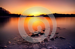 Long exposure photo of water surface and colorful sunset over lake Liptovska Mara at Slovakia