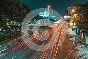 long exposure photo of a busy intersection in the night with many light streaks