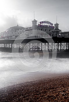 Long exposure photograph of Palace Pier, showing the illuminated pier sign, on a cold, windy, wintry day. photo