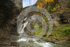 Long exposure photography of  running stream from Estrecho waterfall in Ordesa valley, in Autumn season, photo