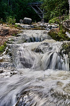 Long-exposure of a picturesque river running over smooth rocks