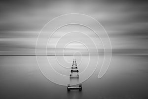 Long exposure of pilings leading into the sea