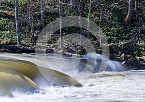 Long exposure of raging water flowing over Valley Falls