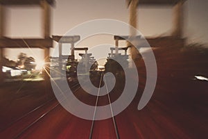 Long exposure railway train travel and movement, concrete infastructure on the side