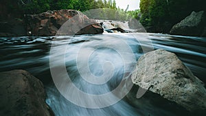 Long exposure scene of flowing waterfall at Tettegouche