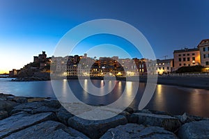 Long exposure in the sea village at night with color houses/ Genoa/Italy/reflexes/lights/ night