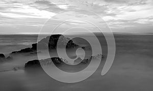 Long exposure of seascape scenery with rocks in black and white,beautiful image can be used nature composition for background and