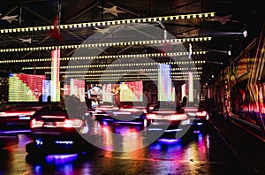 Long exposure shot of glowing bumper cars ride at the annual street fair in St Giles, Oxford