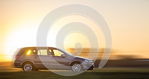 Long exposure shot of gray silver car moving fast in countryside