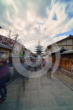 Long exposure shot of historical street in Gion district with lot of tourists walking to the Yasaka pagoda in Kyoto