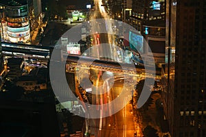 Long exposure shot of intersection with motion blur light trails from the fast moving cars