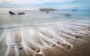 Long exposure shot of Ionian sea vail on the beach of Giardini Naxos, Sicily, Italy