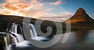 Long exposure shot of the Kirkjufellsfoss waterfall with the Kirkjufell hill in the background