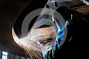 Long exposure shot of a man welding wearing a mask