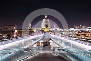Long exposure shot of the millennium bridge surrounded by skyscrapers and buildings