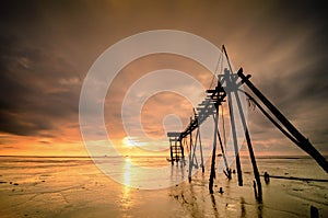 Long exposure shot, old water pump tower with beautiful sunset sunrise with dramatic clouds