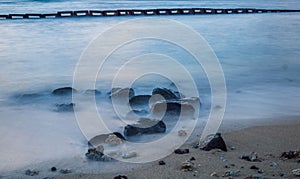 Long exposure shot of rocks on a seashore in Oahu Island, Hawaii