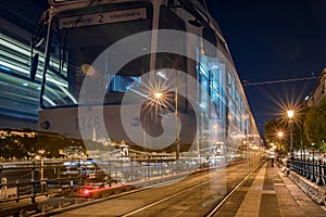 Long exposure shot of a tram running its course in the nighttime Budapest