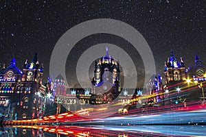 Long exposure shot of vehicle light trails with milkyway and Iconic structure in background. Focus on lights. Mumbai. India photo