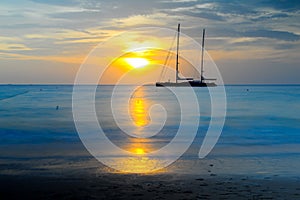 Long exposure silhouette of sailing yacht in Beautiful Sunset