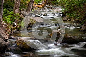 Long exposure of smooth water flowing over rocks at Lithia Park in Ashland Oregon