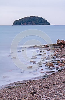 Long Exposure Of Spencer`s Island And Rocky Shoreline photo