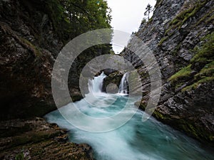 Long exposure of Stromboding waterfall canyon gorge cascade in azure blue river Steyr Hinterstoder Upper Austria alps