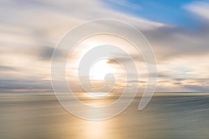 Long exposure of the sun, clouds and sea