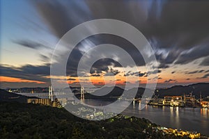 Long exposure sunset photography of Japanese Megami cable-stayed bridge in Nagasaki bay.