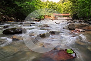 Long exposure to flowing mountain water among stones