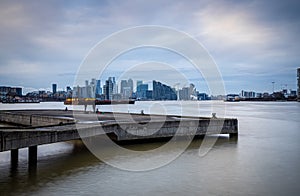 Long exposure view of Canary Wharf and Thames barrier in London