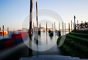 A Long Exposure view of moving Gondolas and Green Steps in Venice, Italy