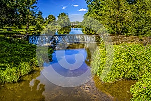 A long exposure view of two weirs across the River Alne at Wootton Wawen, Warwickshire, UK photo